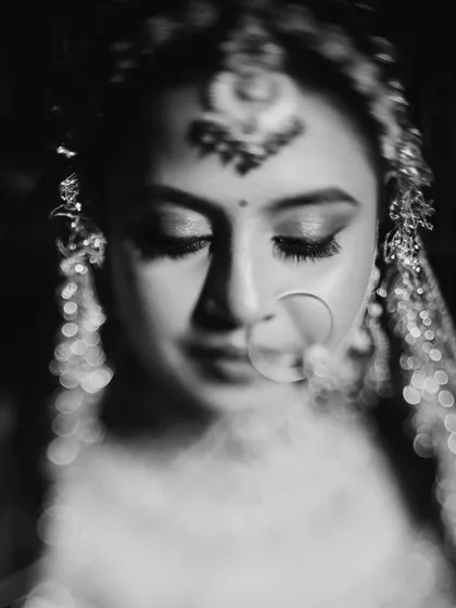 A classic black and white portrait that highlights the timeless quality of the makeup. The contour and eye definition stand out beautifully.