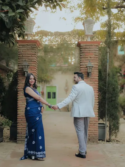 A "follow me to" style shot in a rustic, courtyard-like studio set. This is a popular and fun pose that tells a story of journey and togetherness.