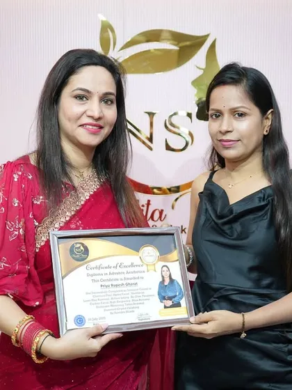 A happy graduate holding her certificate. Every student's success is a testament to our hands-on teaching approach.