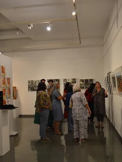 The group gathered around the main gallery space during the walkthrough of 'Southern Stars'.