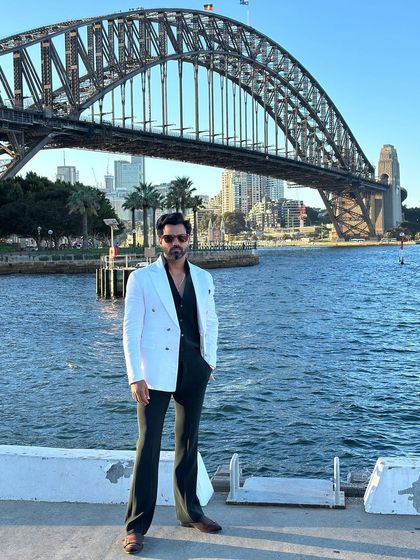 The full ensemble, pairing the white blazer with dark trousers for a classic, high-contrast look.