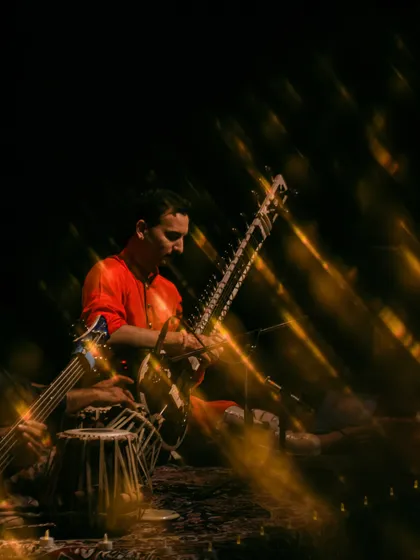 An artistic, light-streaked photo from the Ahmedabad concert, capturing the magical and ethereal quality of the music.