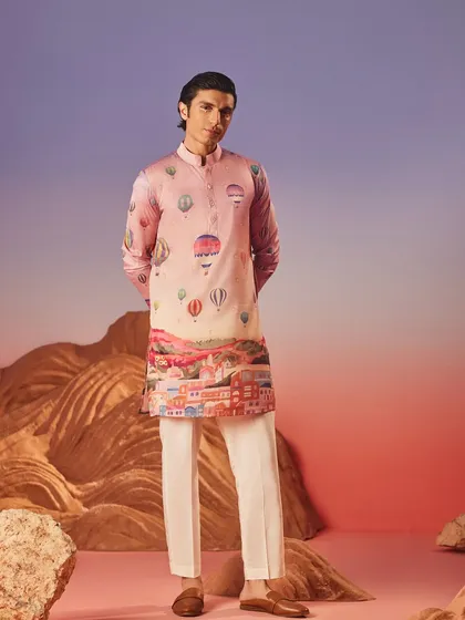This whimsical hot air balloon print kurta in a soft pink hue is a conversation starter. It blends a playful motif with a classic silhouette for a unique festive look.