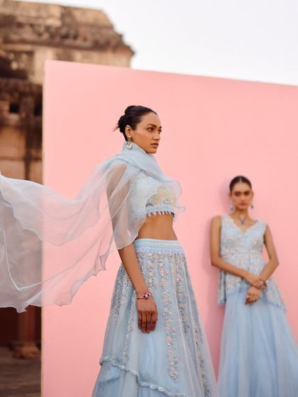 This shot captures the graceful movement of a light organza dupatta. The focus is on the airy, delicate quality of the fabric, which adds a touch of romance to the overall look.