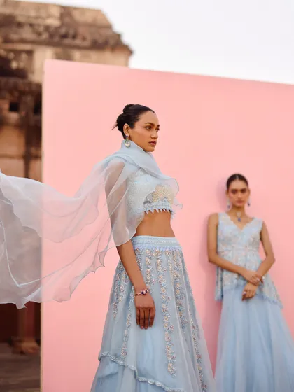 The sheer, flowing dupatta of this blue lehenga catches the wind beautifully. A great inspiration shot from the Awigna campaign.