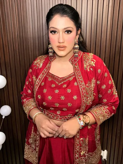 A frontal view, showing how the jhumkas frame her face beautifully.