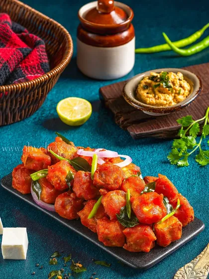 Paneer 65, the vegetarian version of the classic starter. The styling highlights the crispy coating and soft paneer inside.