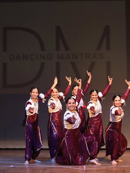 Our Bhangra team in a graceful formation, showcasing traditional mudras and poses. The sequined costumes and coordinated movements highlight the beauty of Punjabi folk dance.
