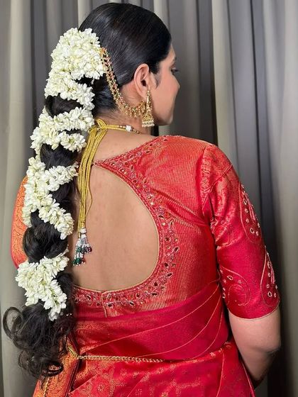 A side view of the jasmine-covered braid, showing its beautiful texture and volume. This is a truly breathtaking look for a South Indian bride.