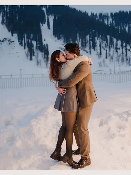 A passionate kiss in the snow. This romantic and cinematic shot perfectly captures the fire of a relationship against a cold, beautiful landscape.