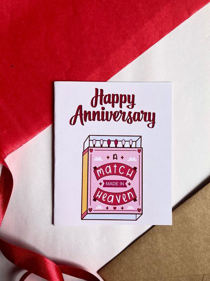 A greeting card is a memory you can keep forever. This 'Happy Anniversary' card with a 'match made in heaven' design is a thoughtful and cute way to express your love.