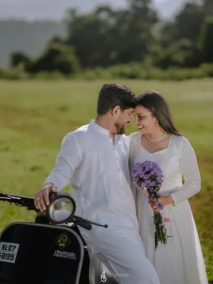 An intimate close-up with the couple and the scooter. The purple bouquet adds a lovely pop of color to the neutral palette.