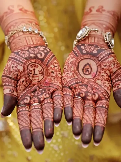 A personalized design for a special occasion. This mehndi includes a one-rupee coin from the bride's birth year and an auspicious swastika symbol.