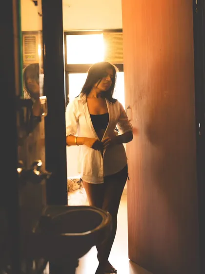 A candid shot that feels like a glimpse into a private moment, using the doorway to frame the scene.