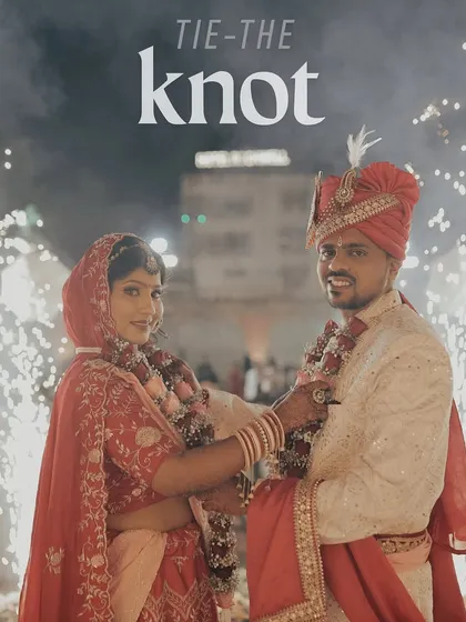 We believe in capturing the joy of the moment. This image, titled "Tie-the-Knot," shows the couple smiling at each other right after their Varmala, surrounded by the explosive energy of cold pyrotechnics.