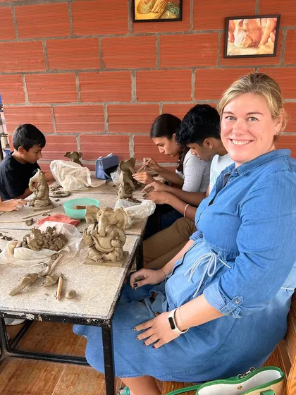 A happy participant in our Ganesha workshop, surrounded by fellow creators. The sense of community is just as important as the art itself.