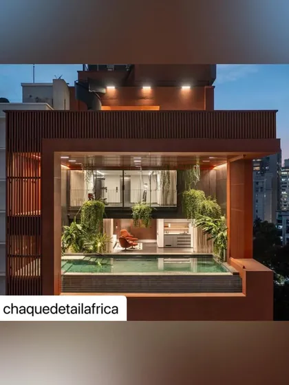The pool and lounge area of the Sarvasva tower at night. The combination of architectural lighting and landscape illumination creates a sophisticated and dramatic space for relaxation.