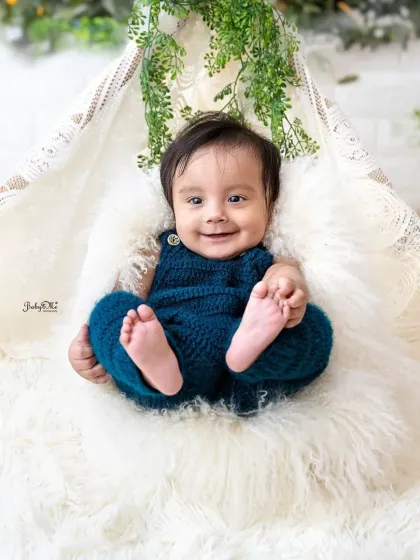 That happy, gummy smile is just infectious. The fluffy white rug and teepee create a soft and cozy environment for these milestone photos.