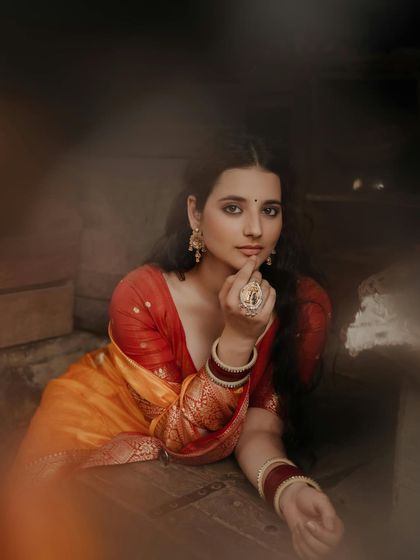 A dreamy, artistic portrait with a soft foreground blur, drawing the viewer's eye to the model's contemplative gaze.