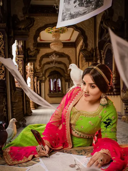 We don't just recreate, we create entire worlds. This artistic, palace-themed photoshoot showcases our creative direction, combining a stunning lime green and pink lehenga with a narrative setting for a truly unique visual story.
