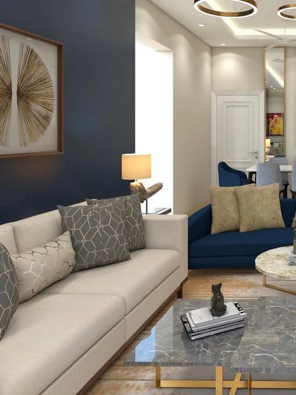 This angle highlights the bold navy accent wall and contemporary artwork in the living room. The mix of geometric and solid cushions on the sofa adds another layer of visual interest.