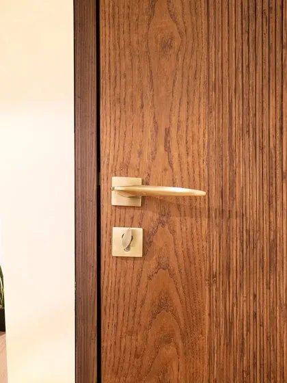 This minimalist fluted door is all about clean lines and subtle texture. The vertical grooves add visual interest without overwhelming the space, perfect for a modern home.
