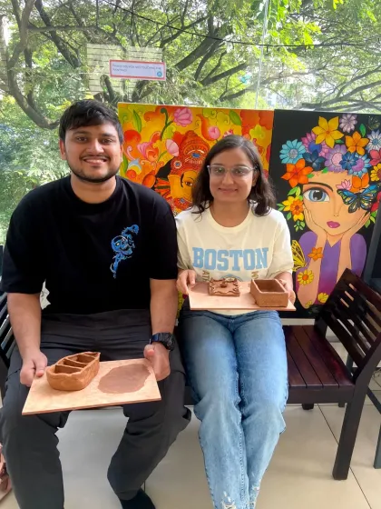 A couple proudly holds up the clay trays they made. It's a fun and practical project that you can use at home.
