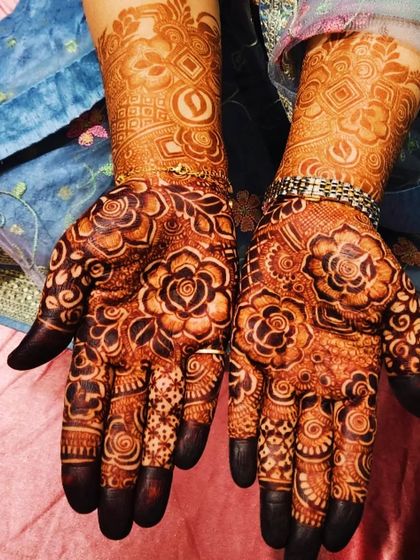 A collection of photos showing the gorgeous results of my henna, from a lighter orange stain to a deep, rich maroon.