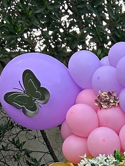 A close-up of a balloon from a butterfly-themed arrangement. A simple butterfly sticker adds a touch of elegance and reinforces the theme.
