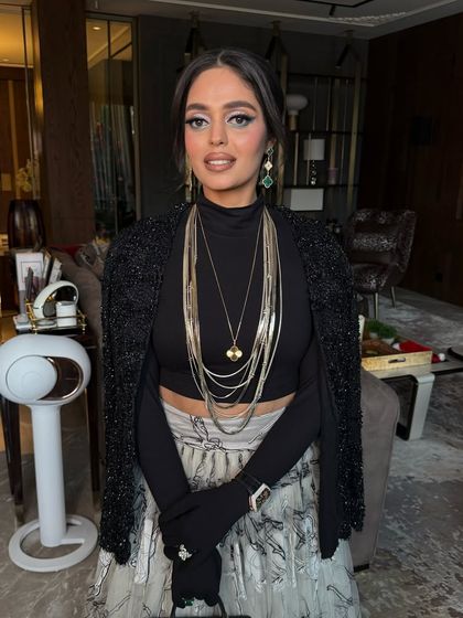 Another shot of the client's festive look, her unique hairstyle making a bold fashion statement.