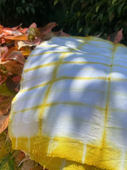 The magical result of dyeing with marigold petals. This cotton linen fabric has been transformed with a beautiful, sunny yellow tie-dye pattern.