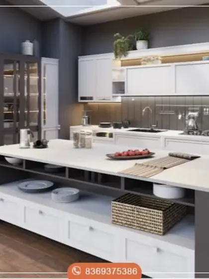 This design showcases a spacious, open-plan kitchen with a large central island providing ample workspace and storage. The contrast between the dark grey island and pantry unit with the clean white cabinetry adds visual depth and modern appeal.