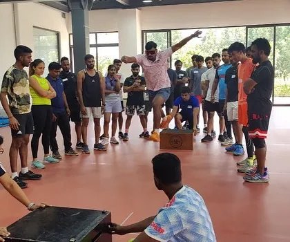I believe in teaching the 'why' behind every movement. Here I am at a plyometrics workshop, demonstrating a jump variation to a group of enthusiastic coaches and athletes. My goal is to share the knowledge I've gained so more people can train effectively and safely.
