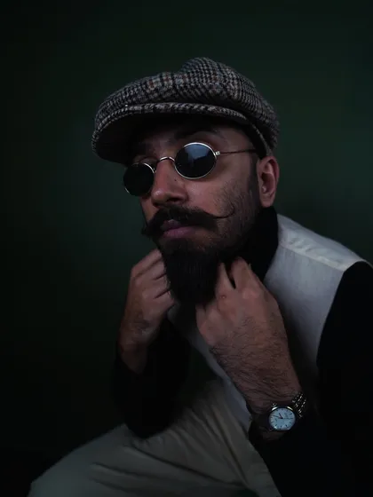A classic portrait look featuring a flat cap and vest. This demonstrates my versatility for timeless men's fashion, grooming products, and headshot photography.
