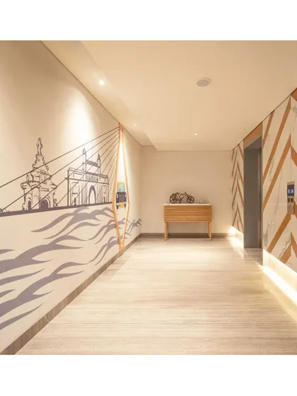 The corridor at IBIS Vikhroli features a stylized mural of the Mumbai skyline, including the Bandra-Worli Sea Link, blending art with architecture to enrich the guest's journey through the hotel.