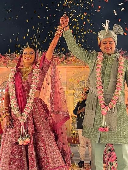 The happy couple celebrating their union on stage. The bride's makeup is designed to be picture perfect, looking fresh and vibrant even from a distance.