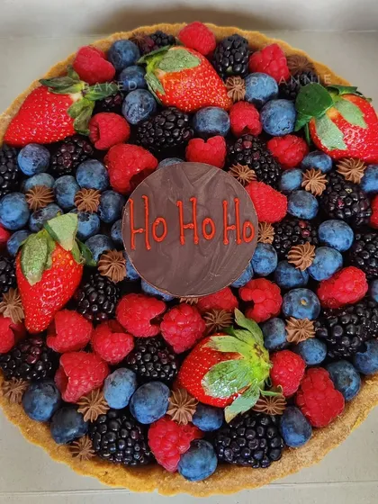 Carrying the holiday spirit into the New Year with my signature dark chocolate tart, topped with fresh winter berries and a festive "Ho Ho Ho" chocolate plaque.