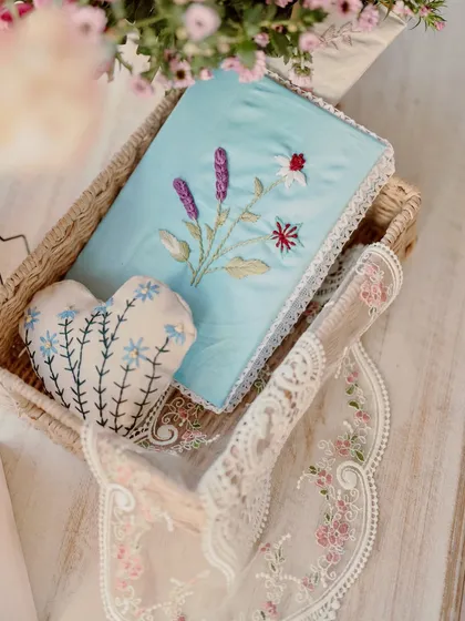Beautifully handcrafted and embroidered pouches and pillows used as decor elements.