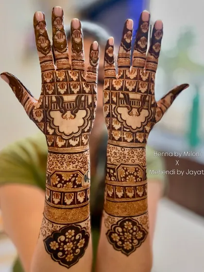 A beautiful bridal design featuring a jharokha with a swing (jhula) inside. The surrounding patterns are a mix of floral and geometric elements.