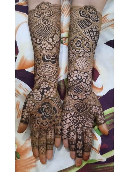 A beautiful example of a full bridal set, featuring a mix of hearts, florals, and checkerboard patterns. The design is balanced and symmetrical, covering the hands and forearms completely.