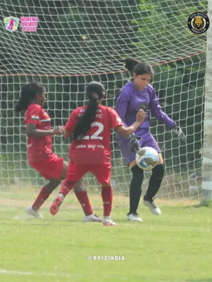 Our goalkeeper confidently collects the ball under pressure from opposing forwards, showcasing her bravery and safe hands.