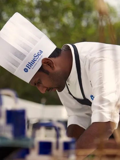 A portrait of one of our chefs, focused and dedicated to his craft. Our experienced culinary team is the driving force behind the excellence and innovation on every menu.