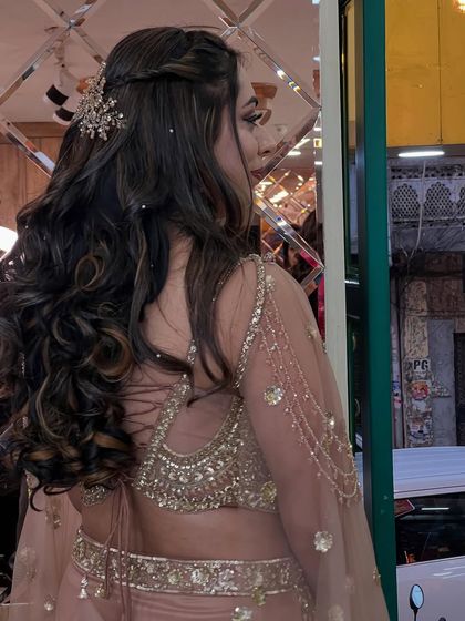 A side profile showing how the hairstyle and accessory complement the intricate design of her blouse.