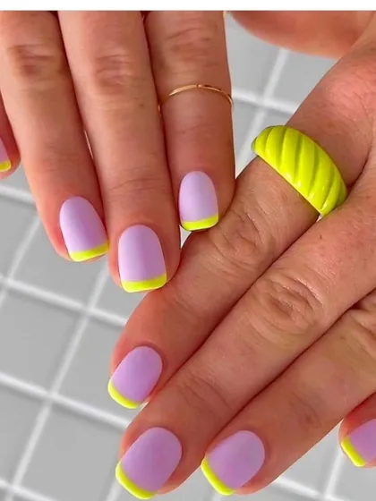 A matte purple manicure with neon yellow French tips. This bold color combination and matte finish create a super trendy and eye-catching look.