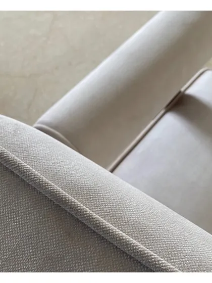 A close-up of the beautiful piping and texture on a custom-made armchair for 'Vishu Home'. This highlights our commitment to quality craftsmanship and meticulous detailing in every piece of furniture we design.