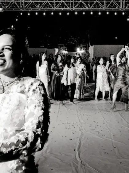 The bride dances with joy during the bouquet toss. This black and white shot captures her happiness and the energy of the moment.