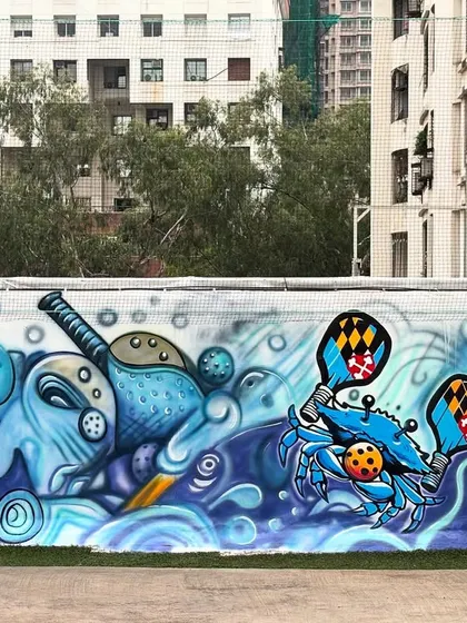 Another view of the main pickleball court mural, full of energy and movement.
