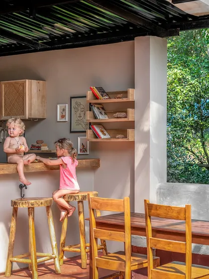 Slow mornings unfold into lively gatherings in the communal area of Unallome. We designed this space with handcrafted wooden stools and tables to invite connection, reflecting our vision of a sanctuary where guests can reconnect with nature and each other.