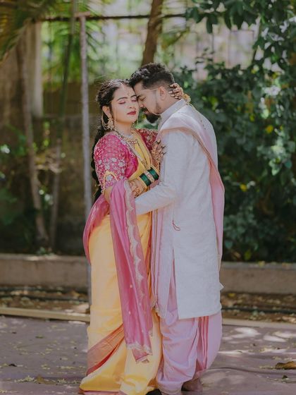 A romantic outdoor portrait of Sonal and Chinmay. The soft light and natural setting enhance the tenderness of their embrace.