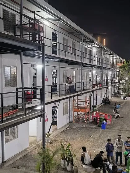 This completed G+2 prefabricated labour colony in Mumbai for Leighton India showcases our ability to deliver complex, multi-story structures. The building, illuminated at night, stands as a testament to our quality construction and on-time project delivery, even in dense urban environments.